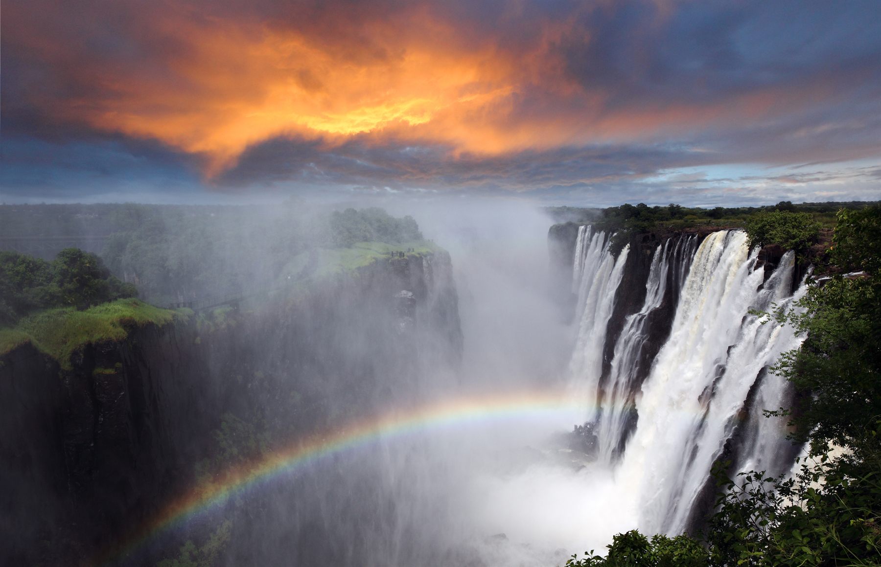 Victoria Falls plunging into its gorge with a rainbow in the spray